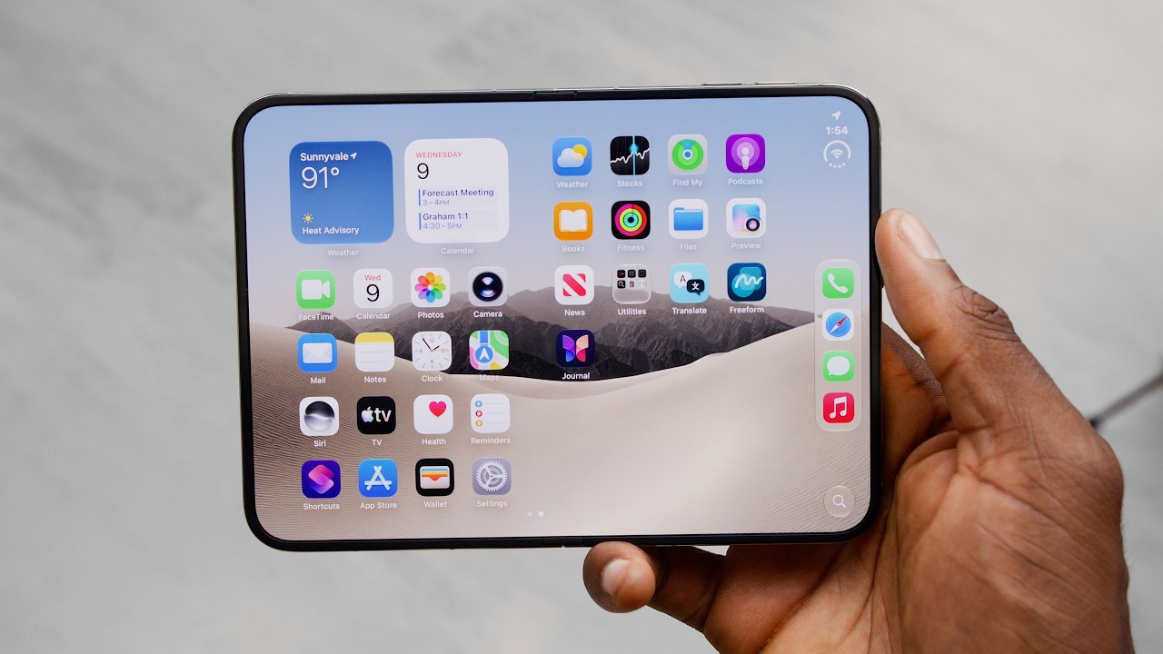 An open folding phone held in one hand